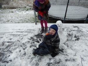 20150713 snow day 1 - snowman, Archie eating snowman's nose